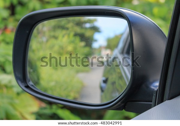 Car Mirror reflect
green grass background