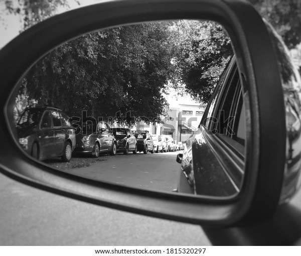 Car mirror that works as a frame, very clear and\
geometric street image. 