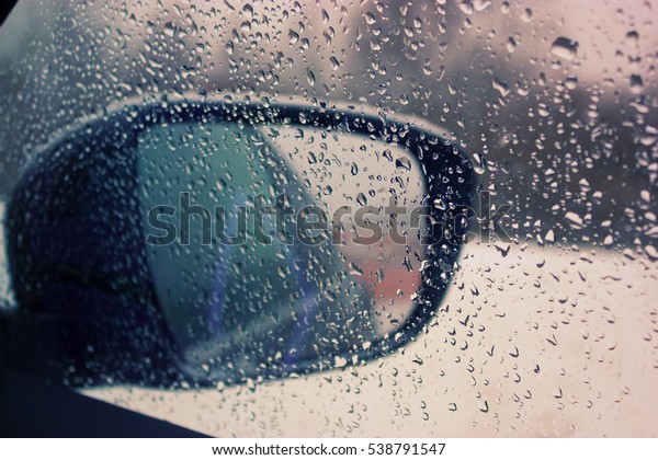 car mirror with water drops\
on it