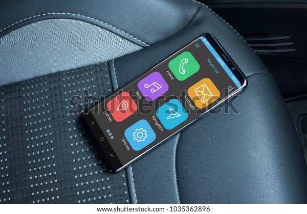 Car mobile app on modern mobile phone with\
flat edges. Smart phone on leather\
seat.