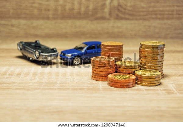 Car model and\
coin on a wooden table as a concept of buying or renting a car.\
Loan for buying a car. Czech money. Financial concept with money.\
Insurance of a car in an\
accident.