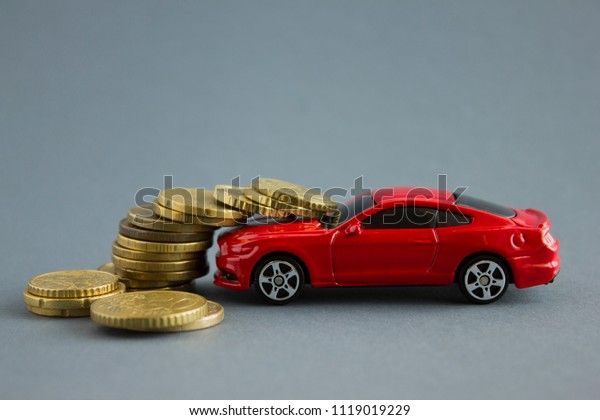 Car model and coins. The concept of car loans,\
leasing, car insurance.