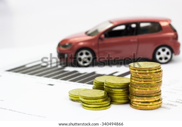 Car model and Financial statement with coins.\
(finance and car loan\
concept)