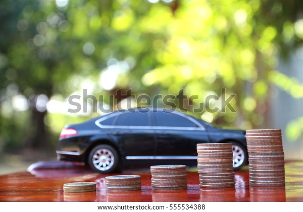 Car model and Financial statement with\
coins, finance and loan concept, saving money\

