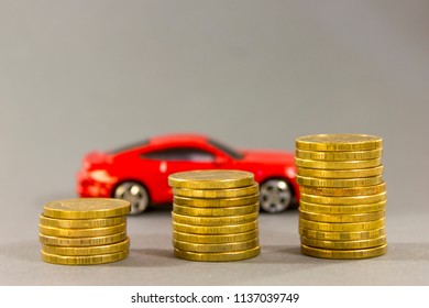 Car Model On  Background Of Coins. Concept Of Leasing, Auto Loan, Auto Insurance, Taxes.