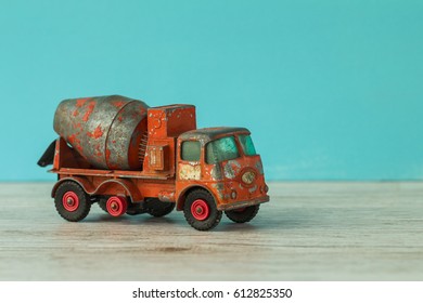 Car Model Orange Old Damaged Dirt Concrete Truck On The Blue Background,  Horizontal 