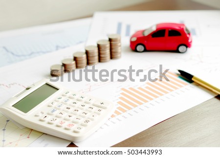  With Car Model And Stack Of Coins On Desk