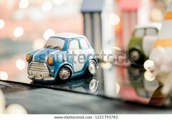 Car models are parked on acrylic\
sheets. And with a shadow car. The background\
blurred.