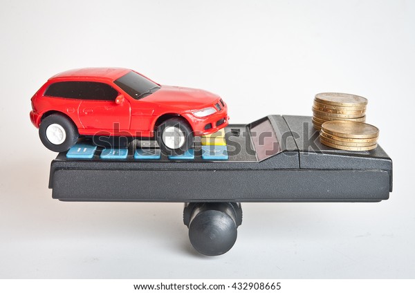 car with money coins on\
the balance Solid Financing of a Car. concept of car loan, Rent,\
car insurance, buy car. Car money and calculator. Payments and\
costs.