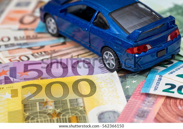 Car\
and money concept - toy automobile with euro\
money.
