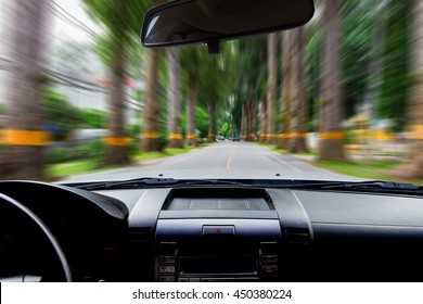 In the car, motion image on the road as background.