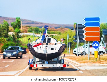 Car with a motor boat on the trailer on the road of Olbia, Costa Smeralda, Sardinia, Italy