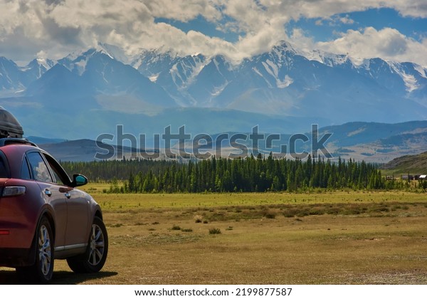 car\
with mountain valley and glacier background. car for traveling.\
Adventure travel concept. Altai mountains, Russia.\
