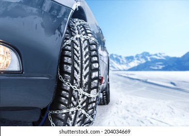 Car with mounted snow chains in wintry environment