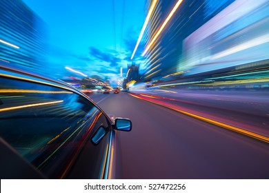 The car moves at fast speed at the night. Blured road with lights with car on high speed. - Shutterstock ID 527472256