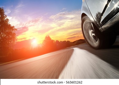 The Car Moves At Fast Speed At The Night. Blured Road With Lights With Car On High Speed