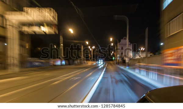 Car moves at fast speed at the night\
streets timelapse hyperlapse drivelapse. Blured road with lights\
reflected from car on high speed. Prague,\
Czech