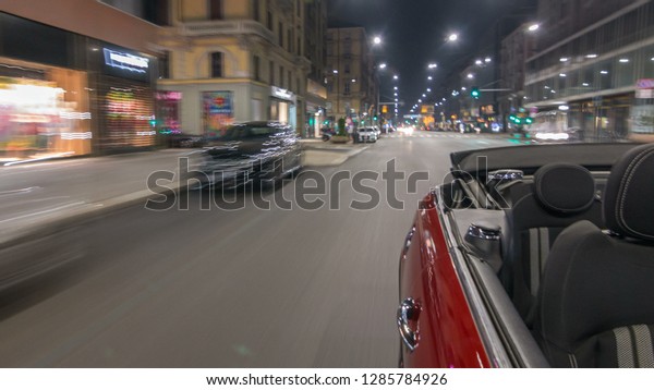 Car moves at fast speed at the night\
avenue timelapse hyperlapse drivelapse. Blured road with lights\
reflected from car on high speed. Milan,\
Italy