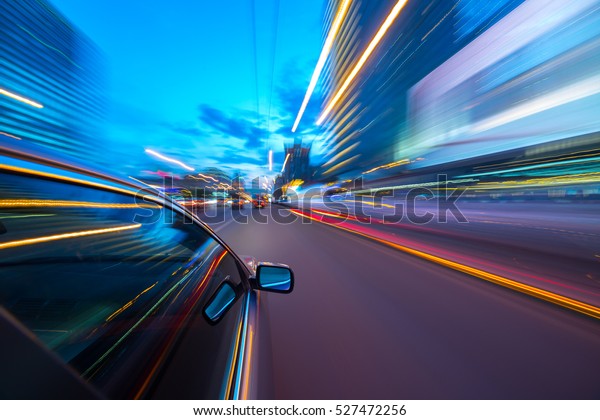 The car moves at fast speed at the
night. Blured road with lights with car on high
speed.