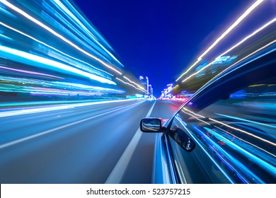 The car moves at great speed at the night. Cold color images.