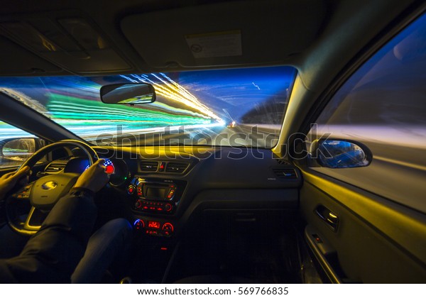 The car moves at great speed at the night. View\
from passenger seat.