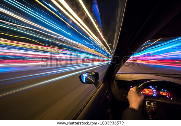 The car moves at high speed at the night. View from\
driver side.