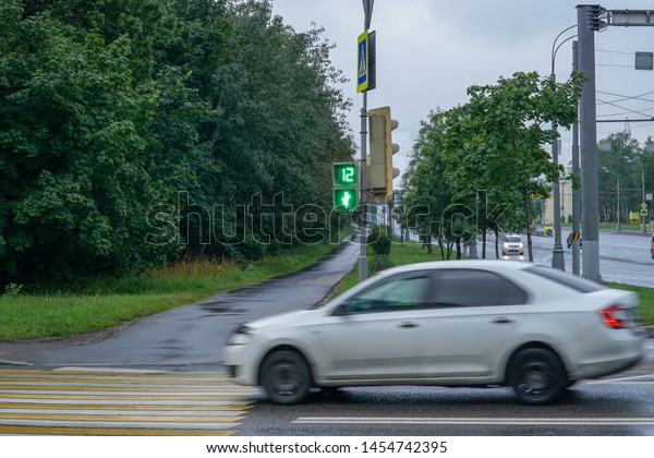   The car moves\
to a pedestrian crossing in green light for pedestrians.           \
                 