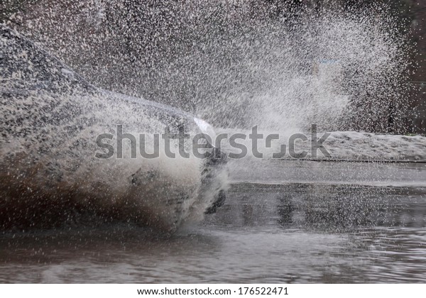 car moving by street at flood
