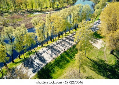 Car Moving On The Road Near The River In European City, Aerial View. Bird Eye View Of Small Town Landscape