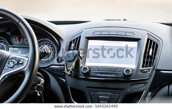 Car navigation system. GPS device in car\
help driver to find the way. Blank screen with place for text. The\
concept of artificial\
intelligence.