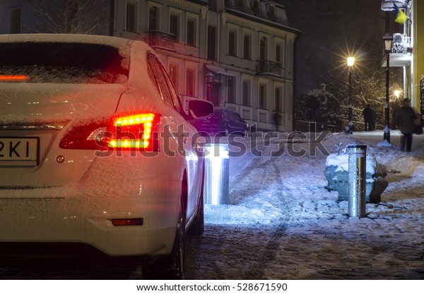 car in night on winter street. Waiting for the\
opening of the barrier