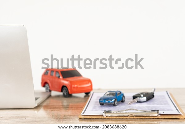 car and notebook Contract documents with
keys on the table, selling and renting
ideas.