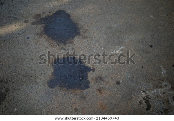 car oil dripping on\
asphalt