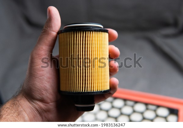 car oil filter in\
hand