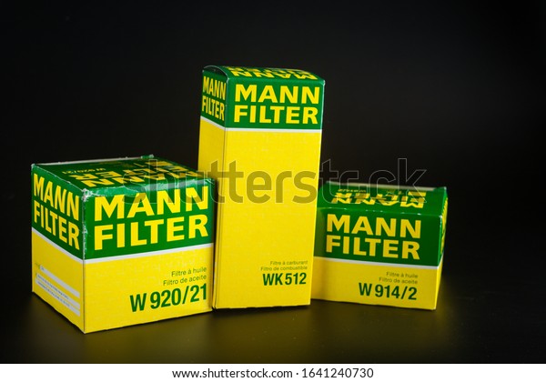 Car oil filter Mann. Mann\
filter. Filters on black background. oil filter in oil change\
pack