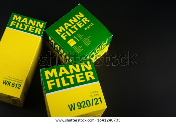 Car oil filter Mann. Mann\
filter. Filters on black background. oil filter in oil change\
pack