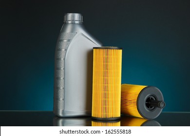 Car Oil Filters And Motor Oil Can On Dark Color Background