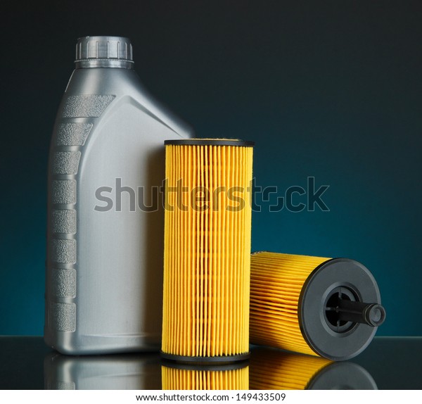 Car oil filters and motor oil can on dark
color background