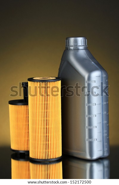 Car oil filters and motor oil can on dark
color background