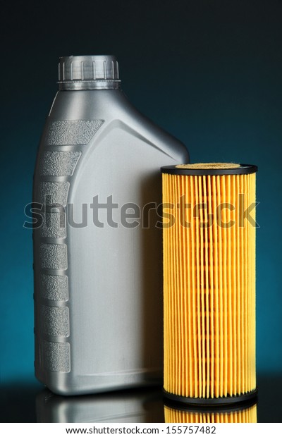 Car oil filters and motor oil can on dark\
color background
