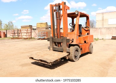 Car -Old Forklift, Forklift, Stacker Truck, Warehouse Forklift. Old Car Under Repair In The Garage.