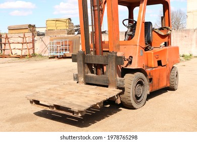 Car -Old Forklift, Forklift, Stacker Truck, Warehouse Forklift. Old Car Under Repair In The Garage.