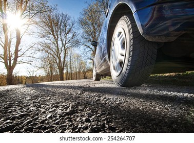 Car On Asphalt Road In Spring Morning