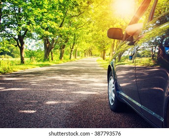 Car on asphalt road in summer