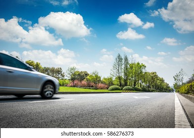 Car on asphalt road on summer day