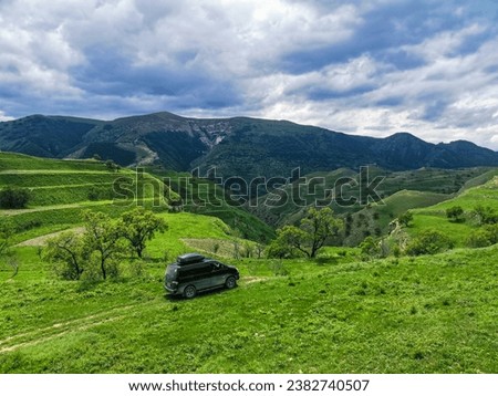 Car on the background views of the mountains of Dagestan near the village of Gamsutl. Russia 2021