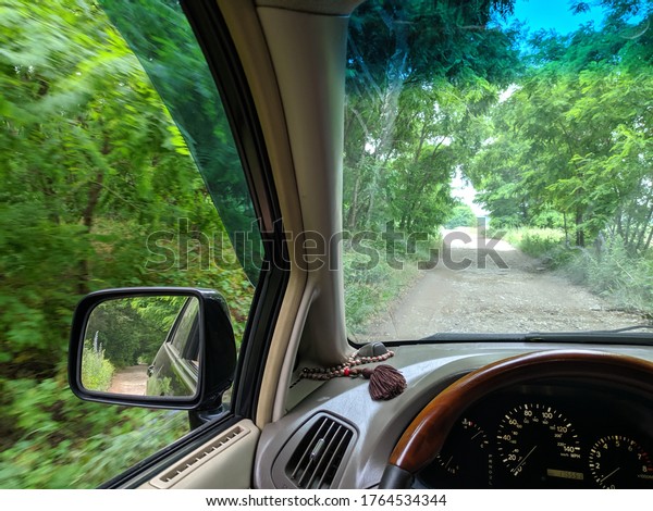 in a car on a bad road. Forest Road. off road on\
a car. driver driving