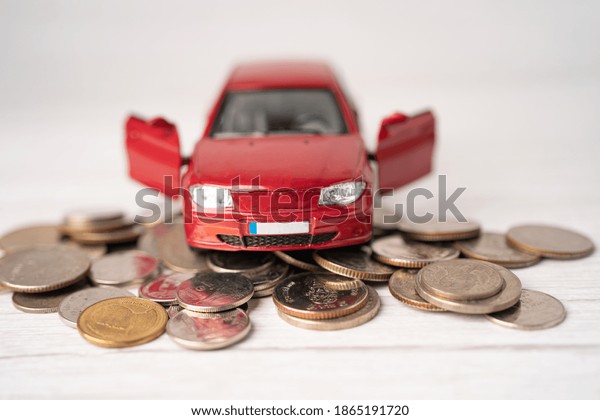 Car on coins background : Car\
loan, Finance, saving money, insurance and leasing time\
concepts.