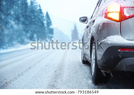 Car on country road in winter day