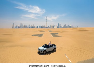 car on a desert road in Dubai